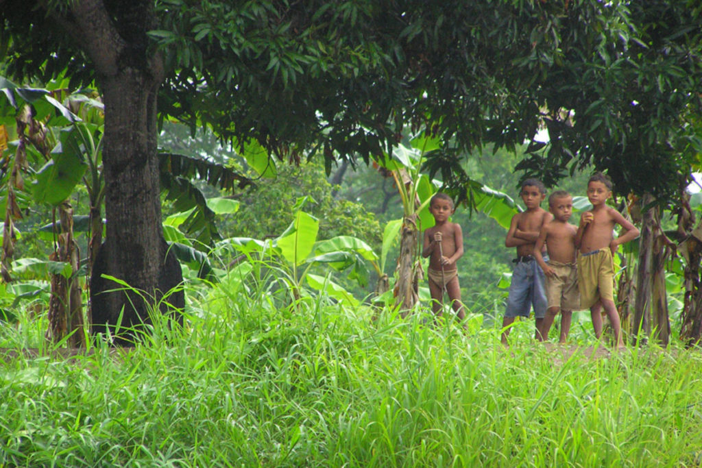 Colombian landscape with curious kids in the background
